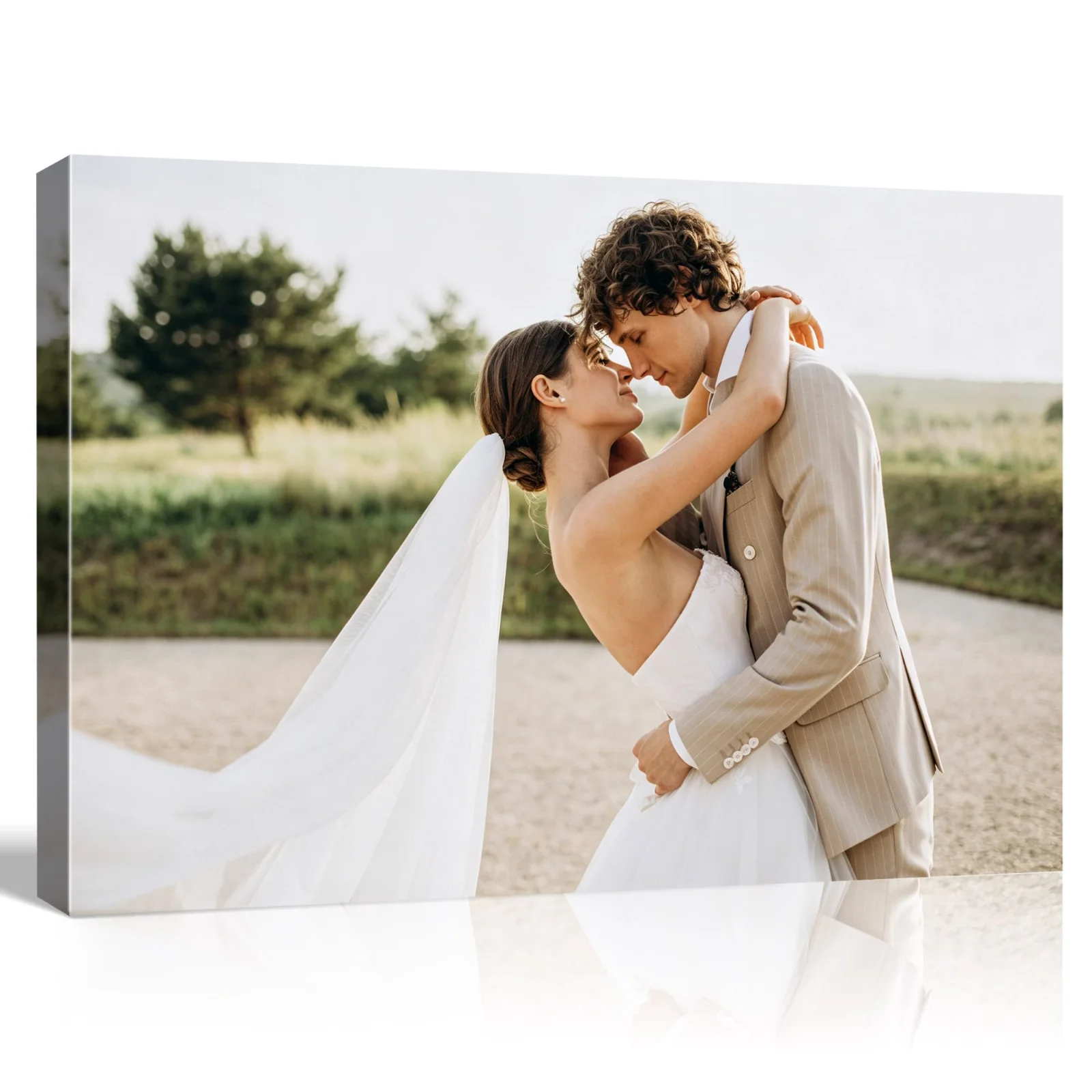 A framed canvas print of a couple embracing outdoors, standing on a pale surface